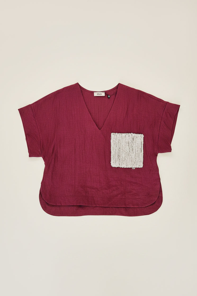 Top con tasca con paillettes bordeaux